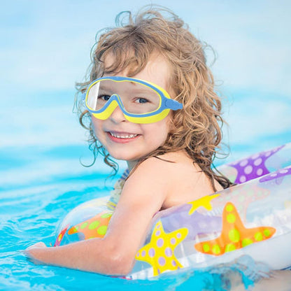 Child wearing swim goggles and an inflatable starfish float in a pool